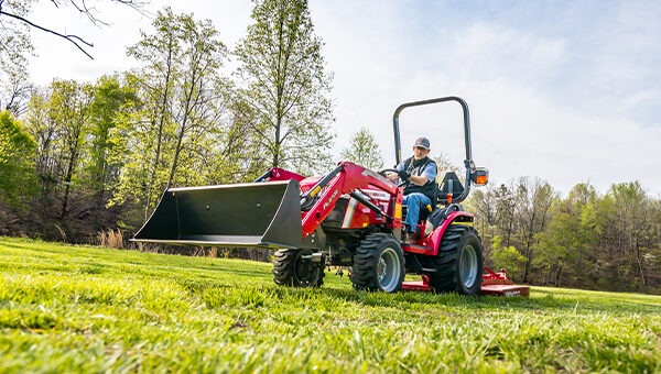 Massey Ferguson 1M Series compact tractor with a front loader and mid-mount mower, perfect for versatile property maintenance and landscaping.