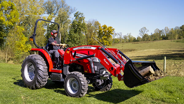 Massey Ferguson 2E Series compact tractor with a front loader bucket, ideal for lifting, hauling, and material handling in various agricultural and landscaping tasks.