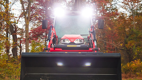 Massey Ferguson 2M Series compact tractor with bright LED work lights and a front loader, providing enhanced visibility for low-light conditions.